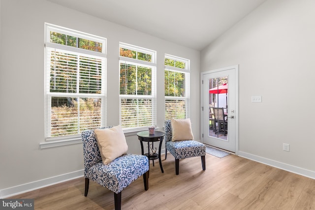 sitting room featuring light hardwood / wood-style flooring and lofted ceiling