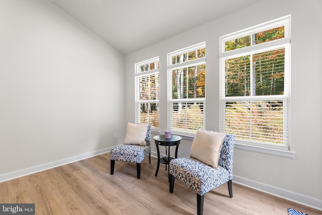 sitting room featuring lofted ceiling and light hardwood / wood-style floors