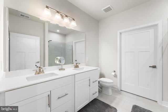 bathroom with a shower with door, toilet, tile patterned floors, and vanity