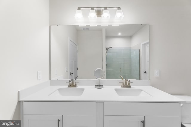 bathroom with vanity, toilet, and walk in shower