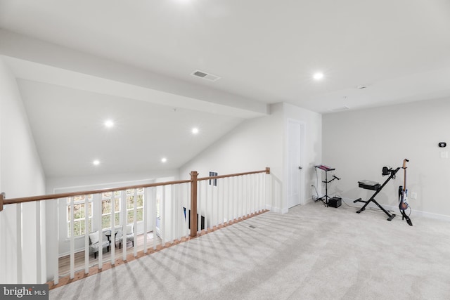 exercise area with light carpet and lofted ceiling