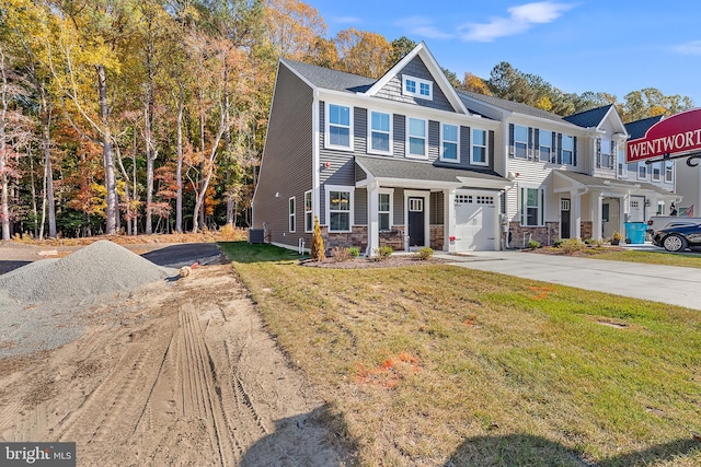 view of front of property with a front yard and a garage