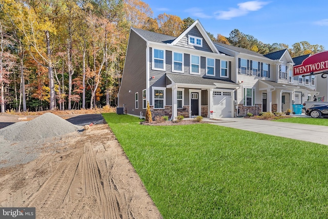 view of front of home with a front yard and a garage