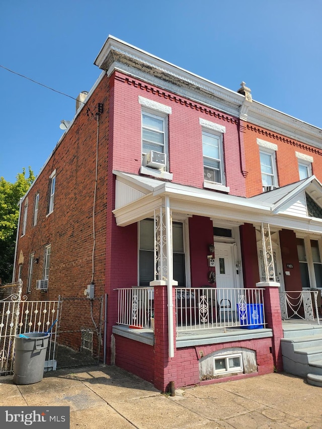 townhome / multi-family property with a porch and cooling unit