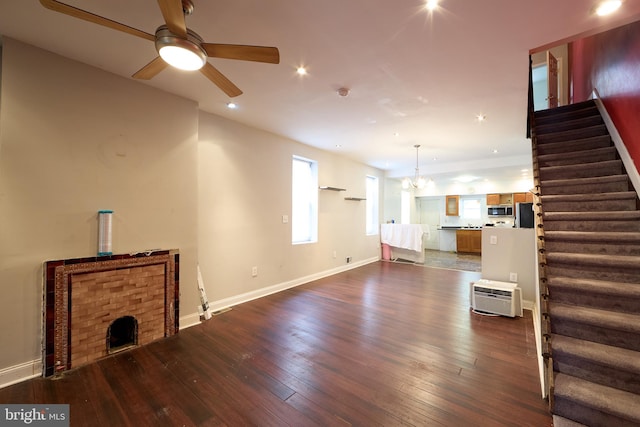 living room featuring dark hardwood / wood-style floors and ceiling fan with notable chandelier