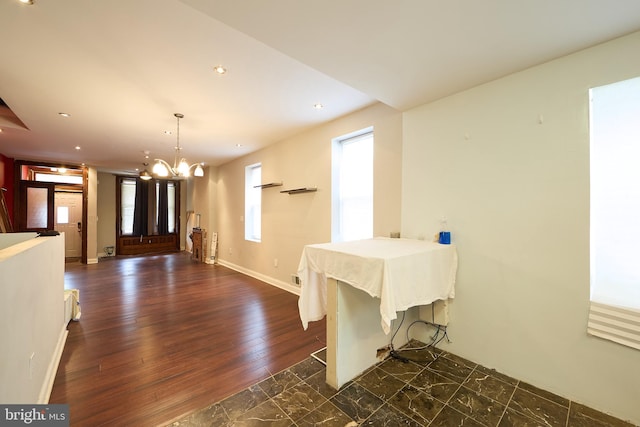 dining area with a chandelier and dark hardwood / wood-style floors