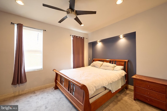 bedroom with light colored carpet and ceiling fan