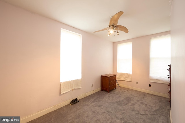 carpeted empty room featuring ceiling fan