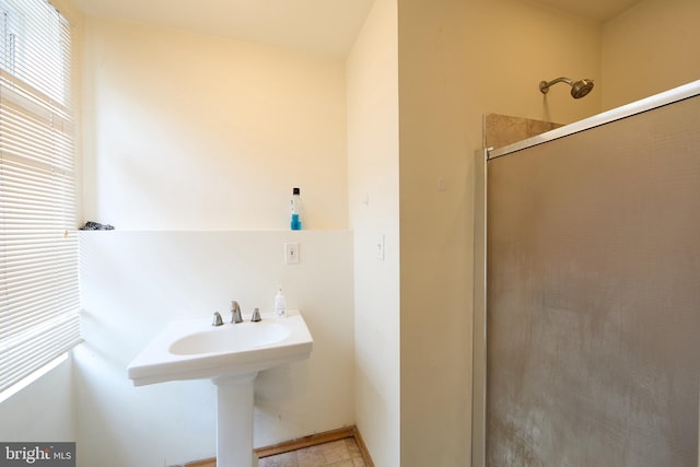 bathroom featuring a shower with shower door