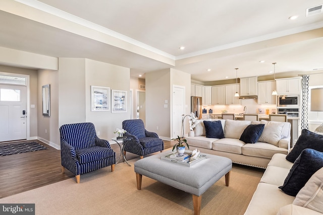 living room with sink and light hardwood / wood-style floors