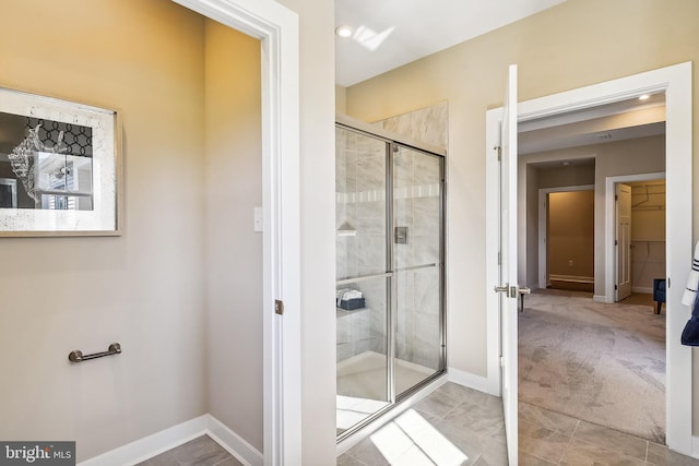 bathroom featuring a shower with door