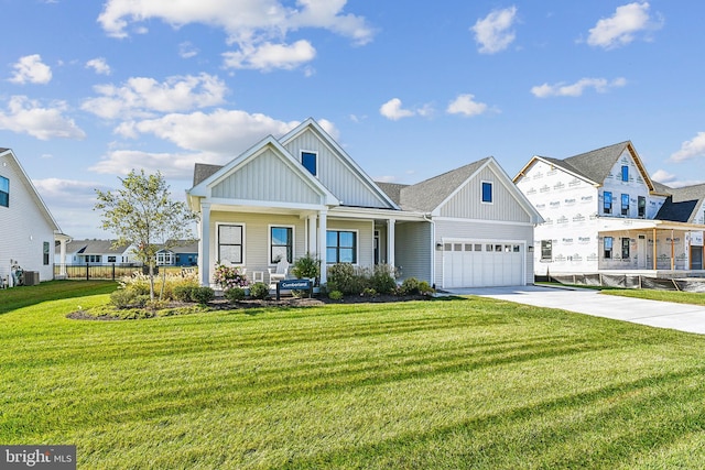 view of front of property featuring a front yard, a garage, cooling unit, and a porch