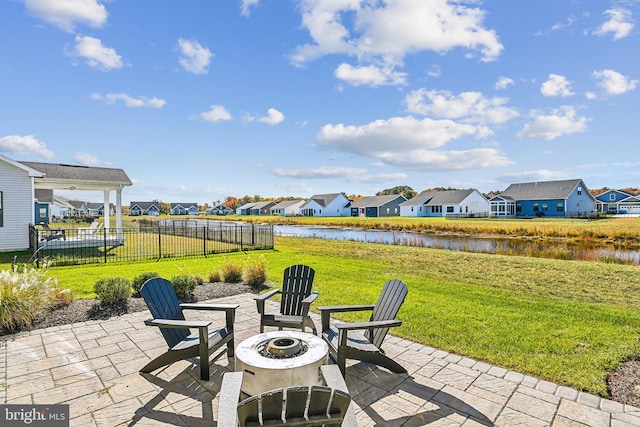 view of patio with a water view and an outdoor fire pit