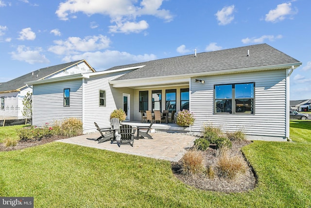 rear view of property featuring a patio area and a lawn