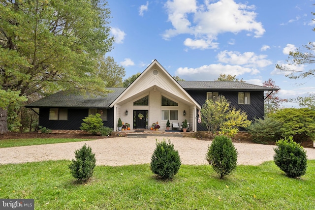 view of front of home with a porch and a front lawn