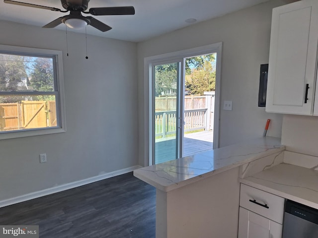 kitchen featuring light stone countertops, dishwasher, kitchen peninsula, white cabinetry, and dark wood-type flooring