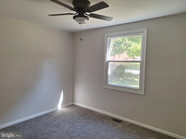 spare room featuring ceiling fan and carpet