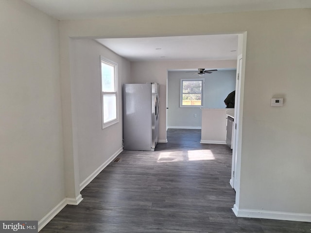 hallway with a wealth of natural light and dark wood-type flooring