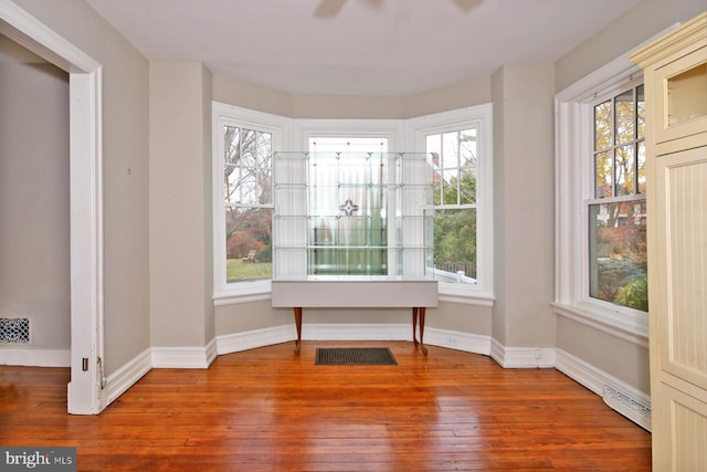 unfurnished sunroom with ceiling fan