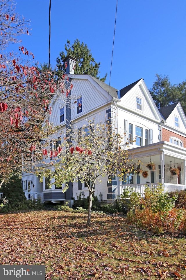 view of side of property with a porch