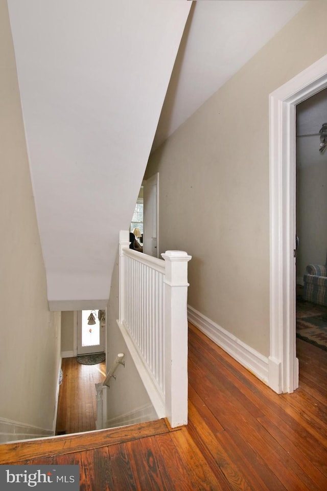 stairway with hardwood / wood-style flooring