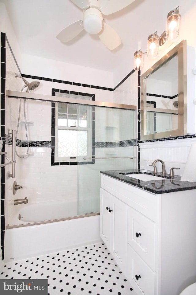 bathroom featuring ceiling fan, combined bath / shower with glass door, and vanity