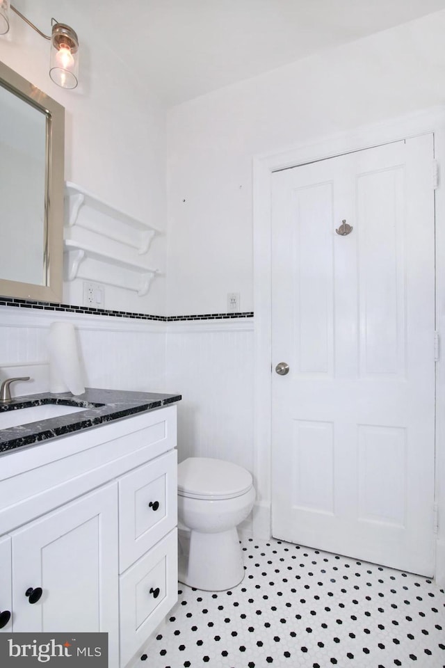 bathroom with tile patterned floors, vanity, and toilet