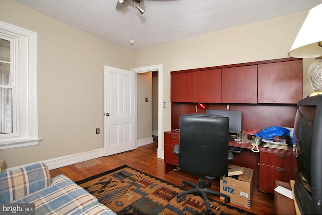 office featuring dark hardwood / wood-style flooring and a textured ceiling