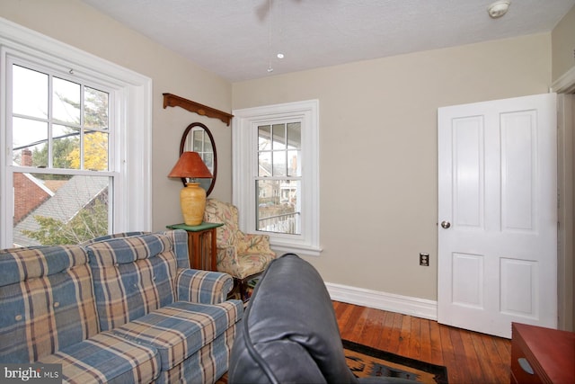 living area with hardwood / wood-style floors and a textured ceiling