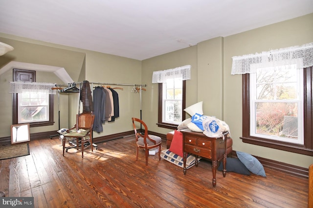 sitting room with dark wood-type flooring