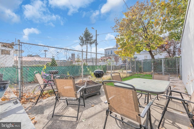 view of patio / terrace featuring an outdoor fire pit