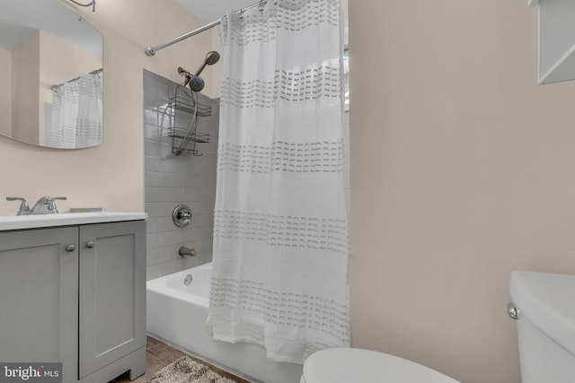 full bathroom with shower / bath combination with curtain, vanity, and toilet