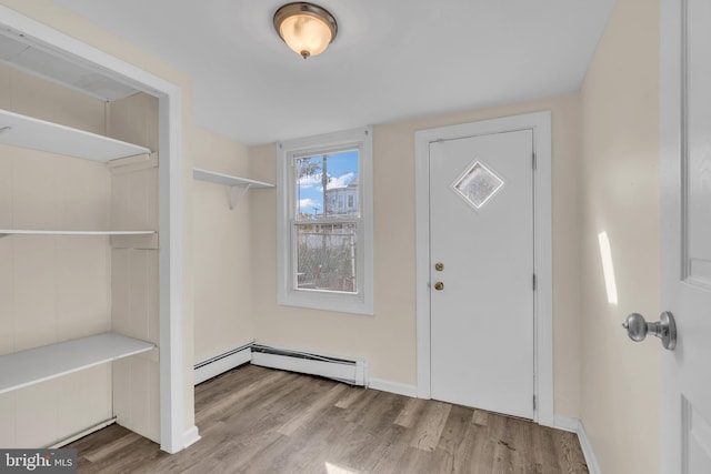 entrance foyer featuring light wood-type flooring and a baseboard heating unit