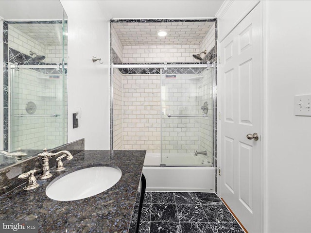 bathroom with bath / shower combo with glass door, marble finish floor, and vanity