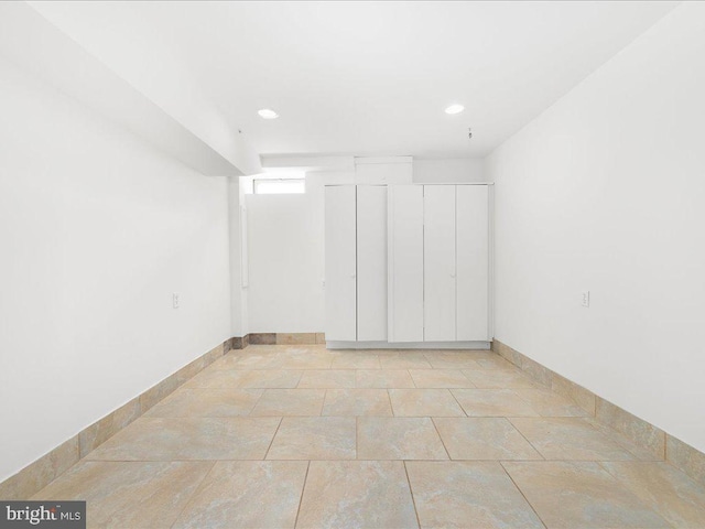 basement featuring baseboards and recessed lighting