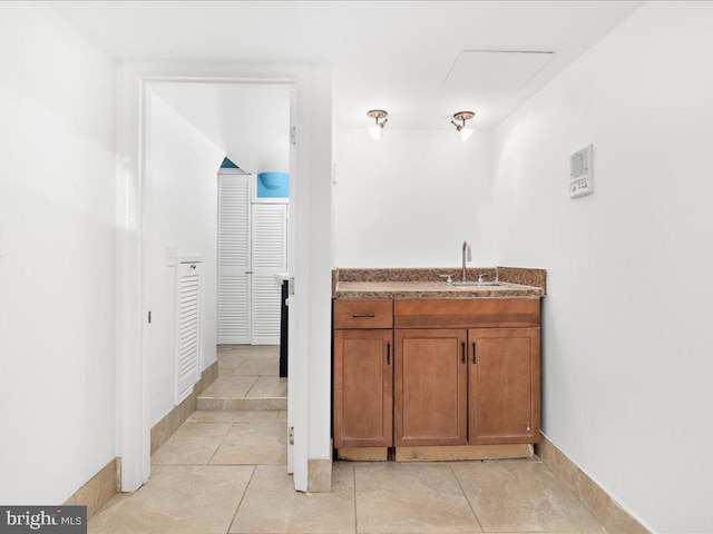 bathroom featuring baseboards, tile patterned flooring, and vanity