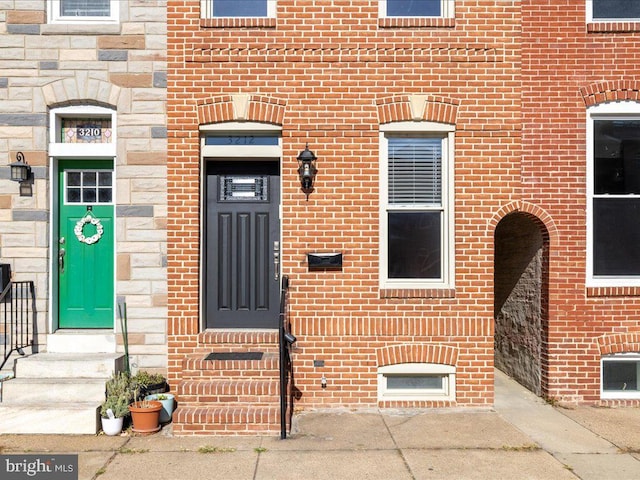 entrance to property with brick siding