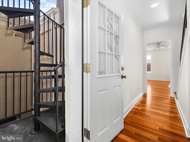 hallway featuring ornamental molding, recessed lighting, stairway, wood-type flooring, and baseboards