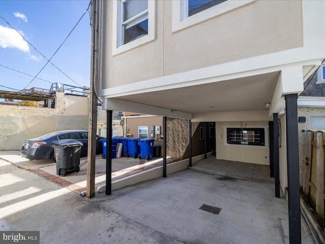 view of patio with fence and a carport
