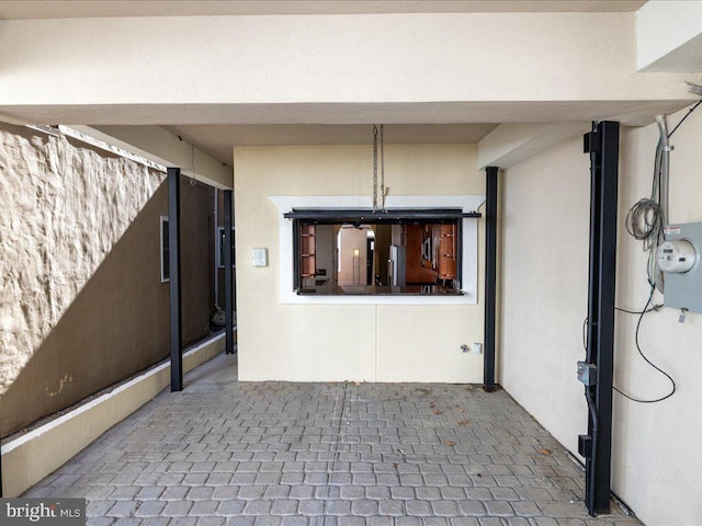 entrance to property featuring stucco siding