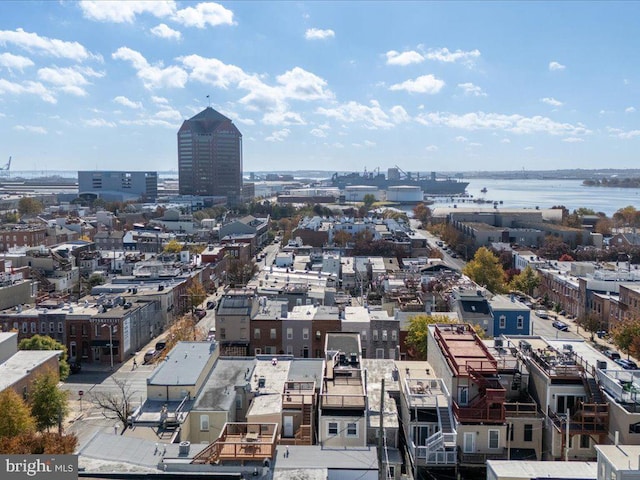 birds eye view of property featuring a city view and a water view