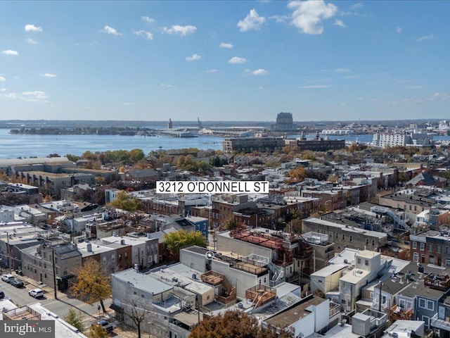 birds eye view of property featuring a city view and a water view