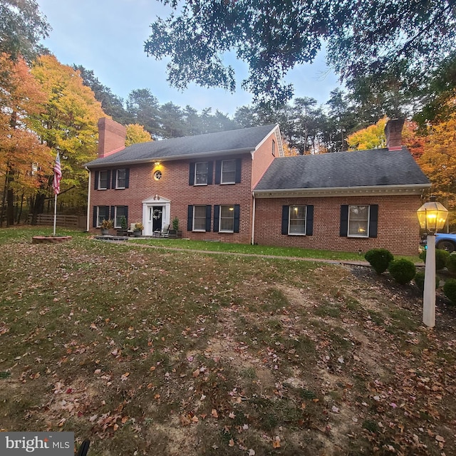 colonial-style house with a front lawn