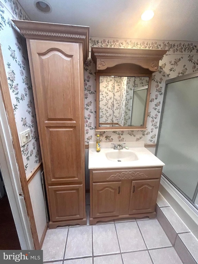 bathroom with tile patterned flooring, vanity, and a shower with shower door