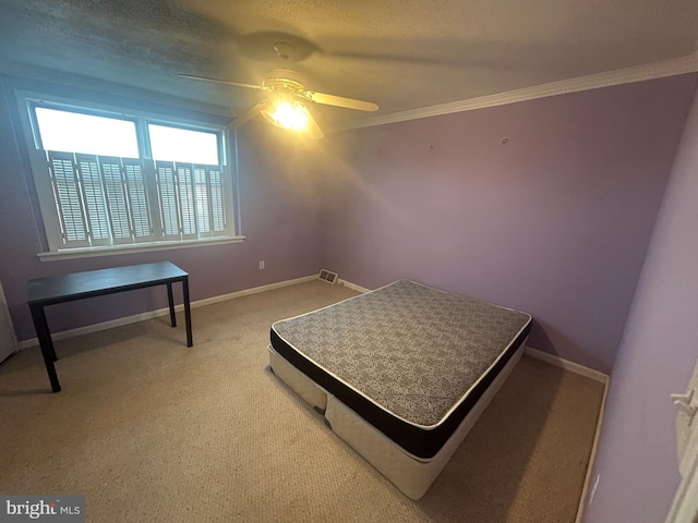 bedroom featuring ceiling fan, carpet, and ornamental molding