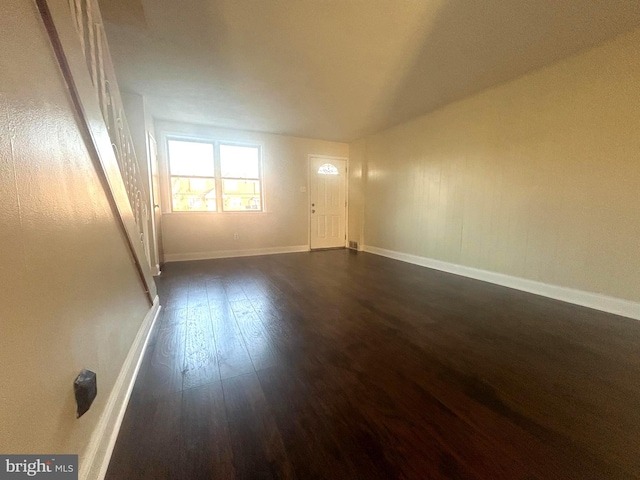 empty room with dark wood-type flooring