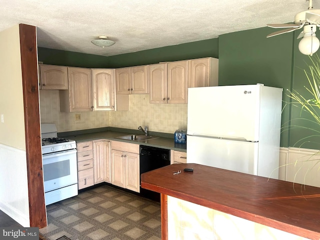 kitchen featuring white appliances, backsplash, sink, ceiling fan, and a textured ceiling