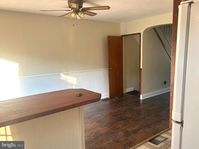 interior space with ceiling fan and a textured ceiling