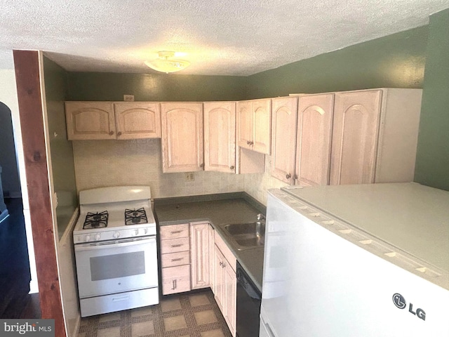 kitchen featuring light brown cabinetry, white appliances, and sink