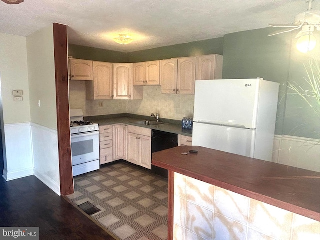 kitchen featuring backsplash, ceiling fan, sink, dishwasher, and white gas stove